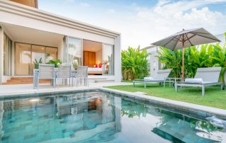 home-house-exterior-design-showing-tropical-pool-villa-with-greenery-garden-sun-bed-umbrella-pool-towels